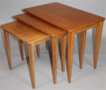 19 A nest of three Russell Of Broadway light oak finish tables