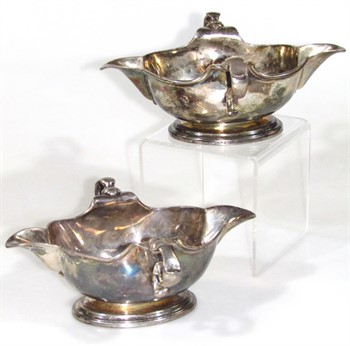 lot 1021 A Harlequin pair of George II silver sauce boats, by George Wickes and John Swift